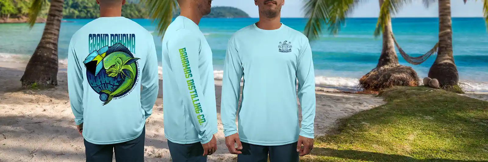 custom Long sleeve shirts in Light blue for Bahamas Distillery in front of a palm covered tropical beach.