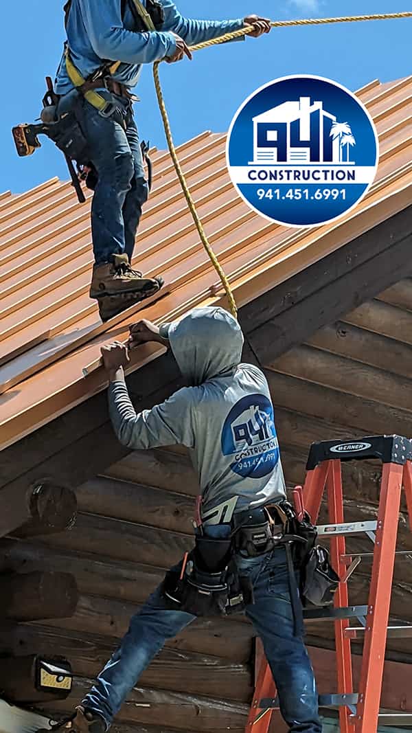 Construction workers working on roof wearing company logo t-shirts with sun hood